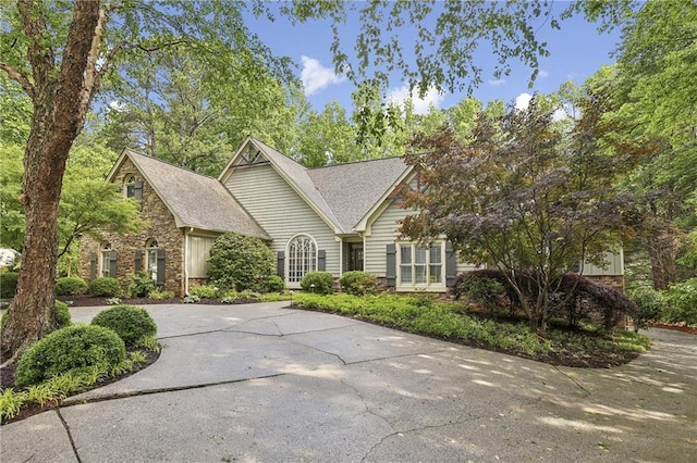 view of front of home with stone siding and concrete driveway