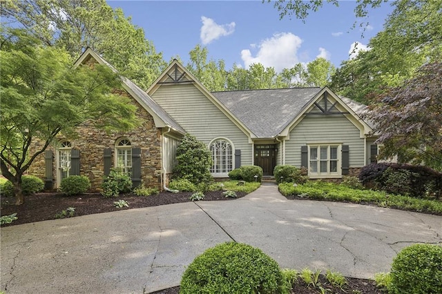 single story home featuring stone siding