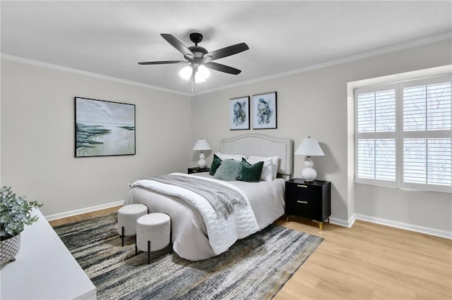 bedroom featuring baseboards, wood finished floors, a ceiling fan, and crown molding