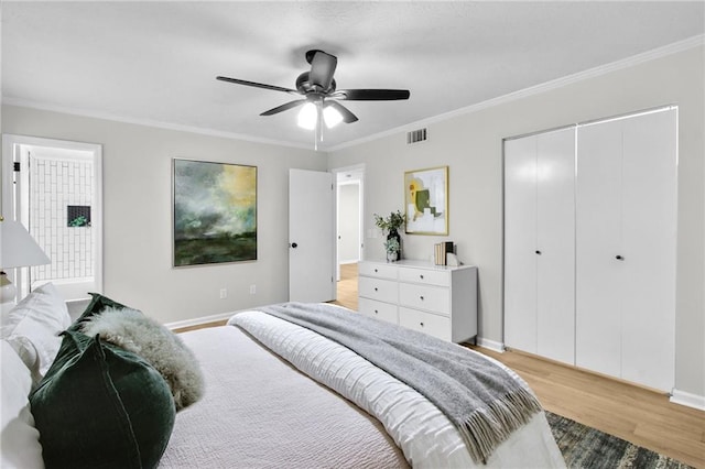 bedroom featuring a closet, visible vents, ornamental molding, light wood-type flooring, and baseboards