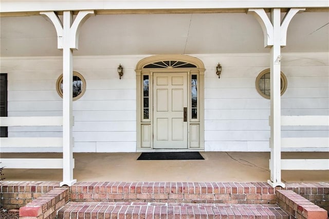 doorway to property featuring covered porch