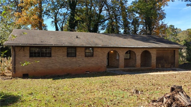 rear view of property with a lawn