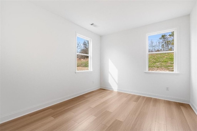 unfurnished room with light hardwood / wood-style flooring