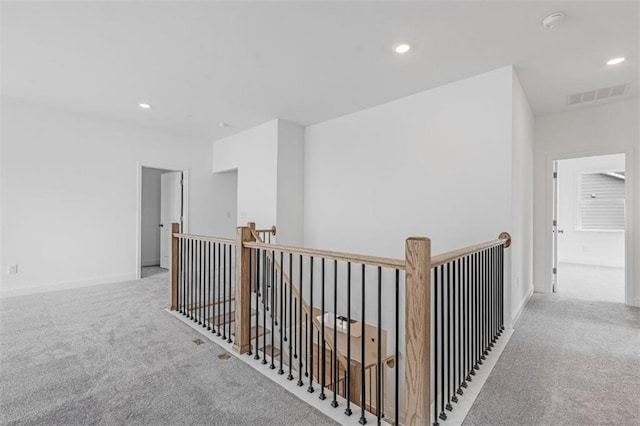 hallway with light colored carpet