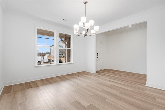 unfurnished dining area featuring crown molding, a chandelier, and light wood-type flooring