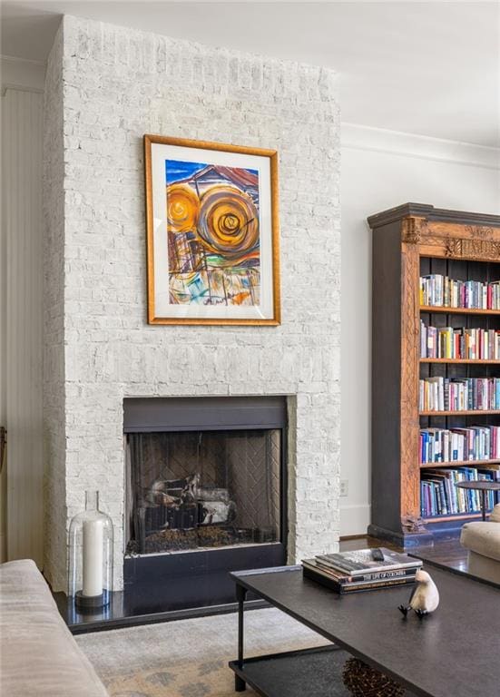 room details featuring a stone fireplace and crown molding