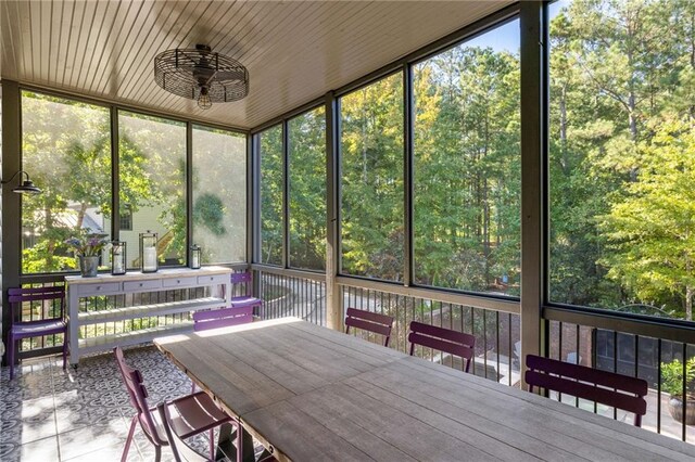 unfurnished sunroom featuring outdoor dining space