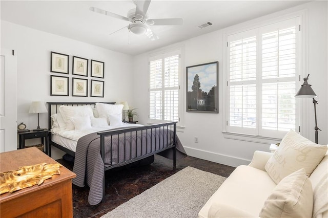bedroom featuring baseboards, visible vents, and a ceiling fan