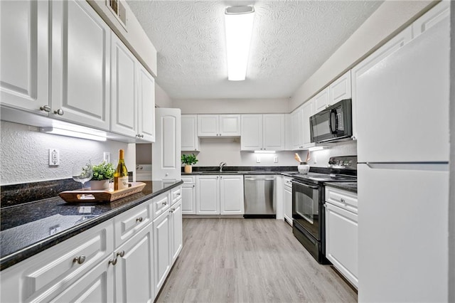 705 Beaufort Cir, Duluth, GA 30096 - kitchen featuring black appliances, white cabinetry, a sink, light wood finished floors, and a textured ceiling