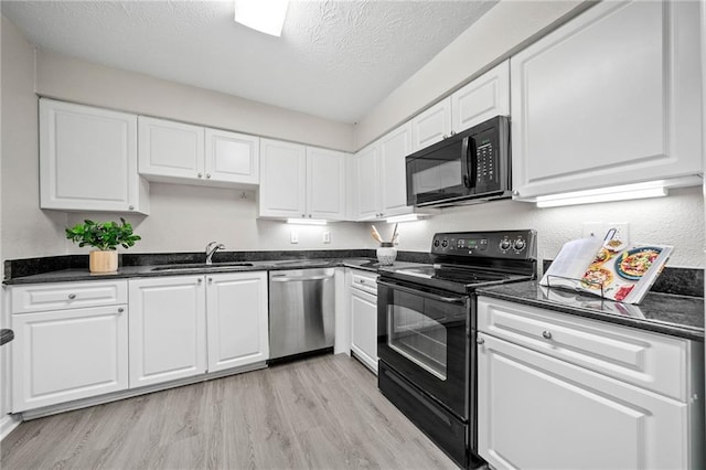 705 Beaufort Cir, Duluth, GA 30096 - kitchen featuring black appliances, a sink, light wood-style flooring, a textured ceiling, and white cabinets