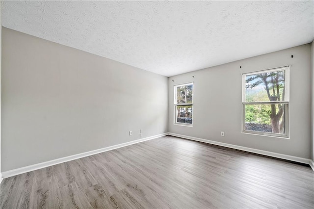705 Beaufort Cir, Duluth, GA 30096 - empty room featuring wood finished floors, a textured ceiling, and baseboards