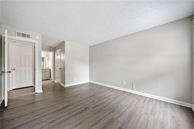 705 Beaufort Cir, Duluth, GA 30096 - spare room with dark wood finished floors, baseboards, and a textured ceiling