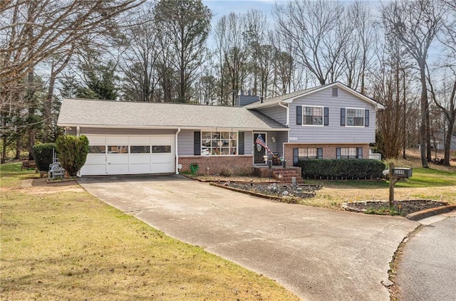 tri-level home featuring brick siding, a garage, driveway, and a front lawn