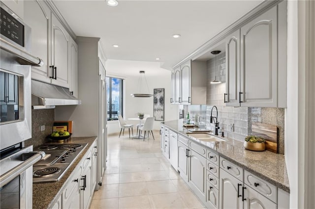 2660 Peachtree Rd NW Unit 23A, Atlanta, GA 30305 - kitchen featuring stainless steel appliances, tasteful backsplash, recessed lighting, dark stone countertops, and pendant lighting