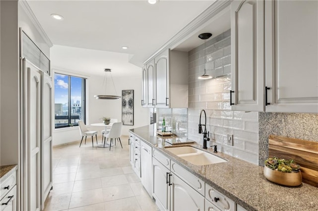 2660 Peachtree Rd NW Unit 23A, Atlanta, GA 30305 - kitchen featuring backsplash, decorative light fixtures, light tile patterned floors, stone counters, and recessed lighting