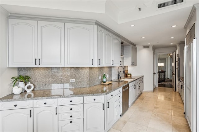 2660 Peachtree Rd NW Unit 23A, Atlanta, GA 30305 - kitchen featuring light stone counters, tasteful backsplash, stainless steel dishwasher, recessed lighting, and white cabinets