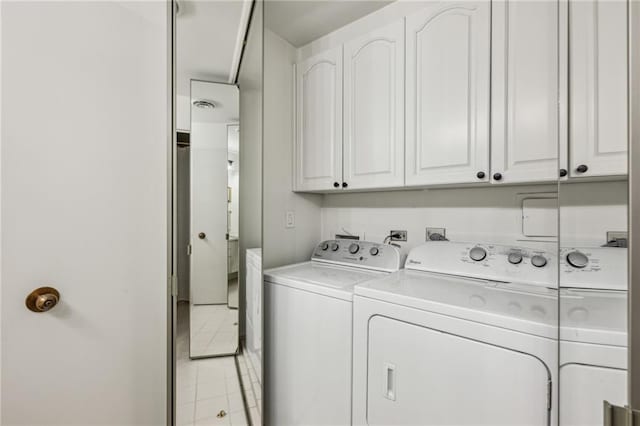 2660 Peachtree Rd NW Unit 23A, Atlanta, GA 30305 - laundry area featuring washer and dryer, cabinet space, and light tile patterned flooring