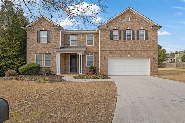 view of front of home with brick siding, driveway, and a garage