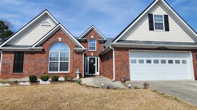 traditional home featuring brick siding, concrete driveway, and a front yard