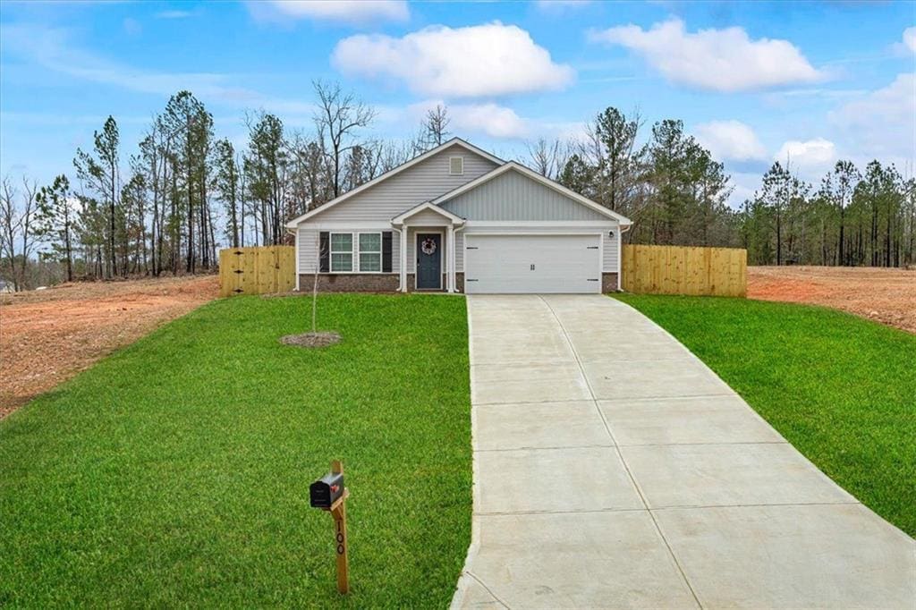 view of front of property with a garage and a front yard