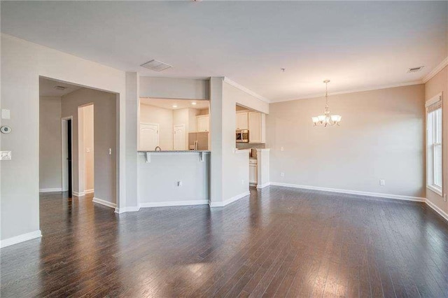 unfurnished living room with crown molding, a chandelier, and dark hardwood / wood-style floors