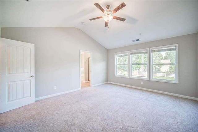 carpeted spare room with lofted ceiling and ceiling fan