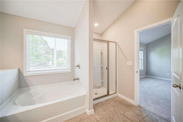 bathroom with lofted ceiling, tile patterned flooring, and independent shower and bath