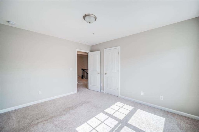 spare room featuring light colored carpet