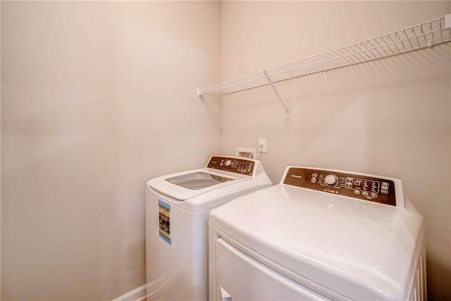 washroom with washing machine and clothes dryer