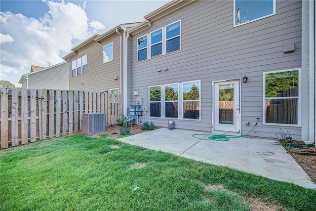 back of property with a lawn and a patio area