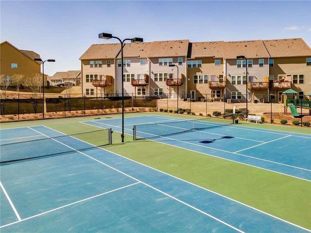 view of tennis court with basketball court and a playground