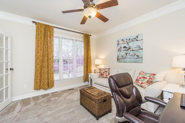 carpeted home office featuring ornamental molding and ceiling fan