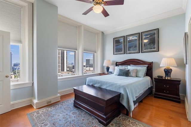 bedroom with ceiling fan and light wood-type flooring