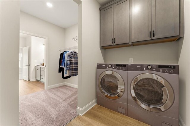 264 Azalea Xing, Dallas, GA 30132 - laundry room with washer and clothes dryer, cabinet space, light wood-type flooring, and baseboards