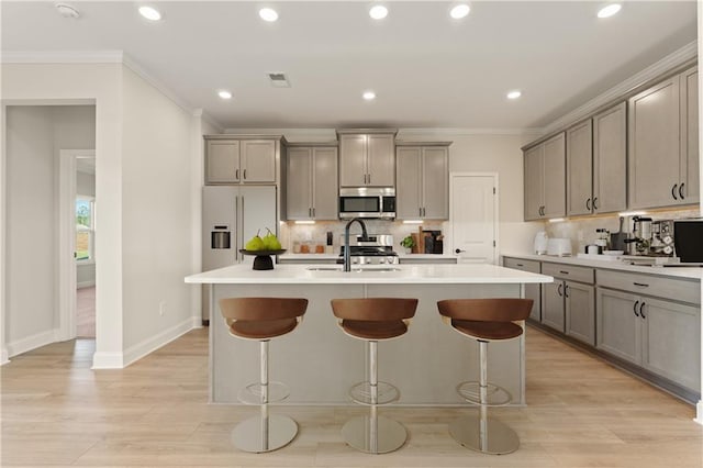 264 Azalea Xing, Dallas, GA 30132 - kitchen with stainless steel microwave, built in fridge, gray cabinets, a kitchen island with sink, and crown molding