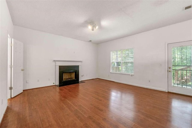 unfurnished living room featuring wood-type flooring