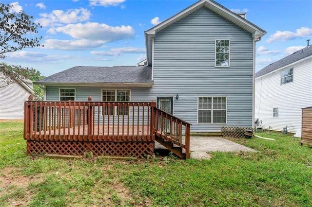 back of house featuring a wooden deck and a lawn