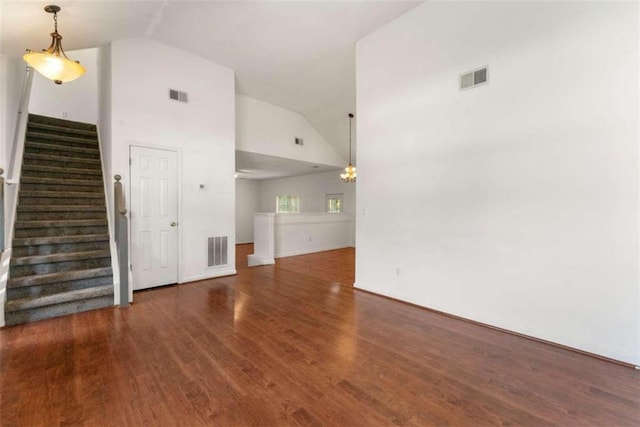 unfurnished living room featuring dark hardwood / wood-style flooring and high vaulted ceiling