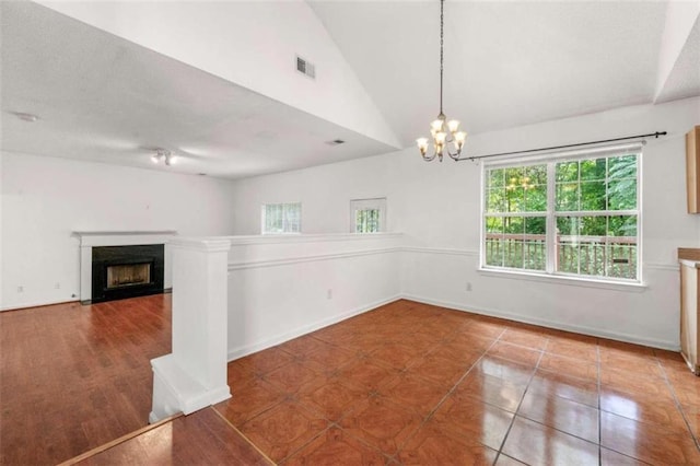 interior space featuring lofted ceiling, a chandelier, and tile patterned flooring