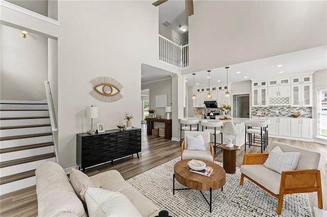 479 Rising Sun Path, Lawrenceville, GA 30043 - living room featuring light wood-style flooring, a towering ceiling, stairs, recessed lighting, and a ceiling fan