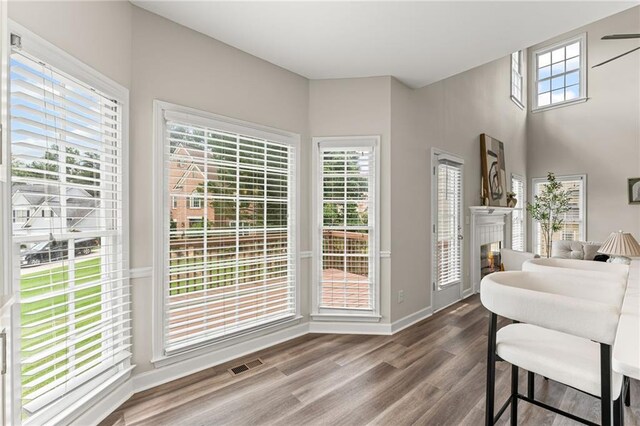 479 Rising Sun Path, Lawrenceville, GA 30043 - dining area featuring a lit fireplace and wood finished floors