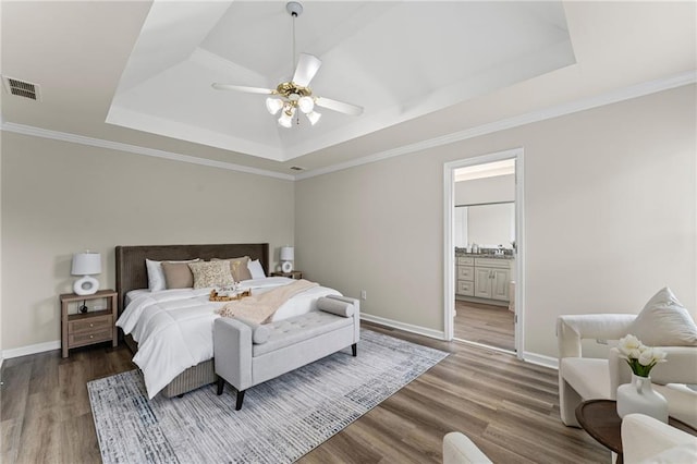 479 Rising Sun Path, Lawrenceville, GA 30043 - bedroom featuring a tray ceiling, wood finished floors, ensuite bathroom, and a ceiling fan