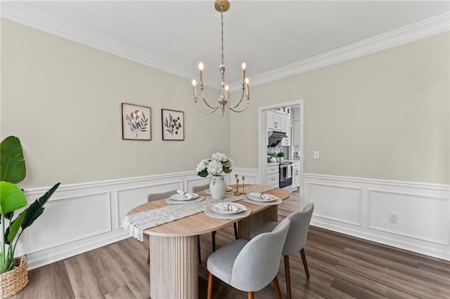 479 Rising Sun Path, Lawrenceville, GA 30043 - dining room featuring a chandelier, crown molding, wainscoting, dark wood-type flooring, and a decorative wall