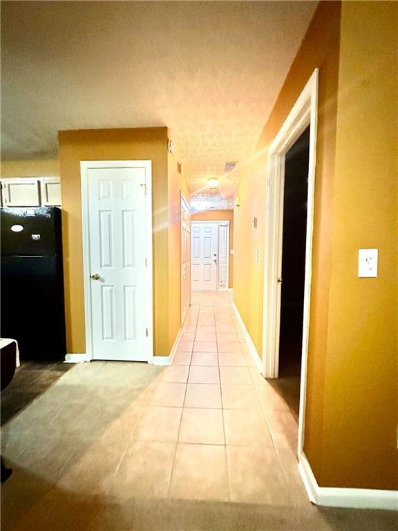 3793 Mays Ct SW, Atlanta, GA 30331 - hallway featuring light tile patterned floors and baseboards