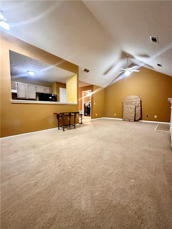 3793 Mays Ct SW, Atlanta, GA 30331 - additional living space with carpet, baseboards, vaulted ceiling, ceiling fan, and a textured ceiling