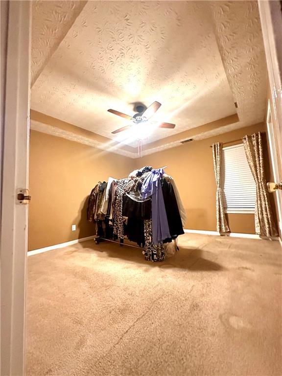 3793 Mays Ct SW, Atlanta, GA 30331 - carpeted bedroom with a textured ceiling, baseboards, and a ceiling fan