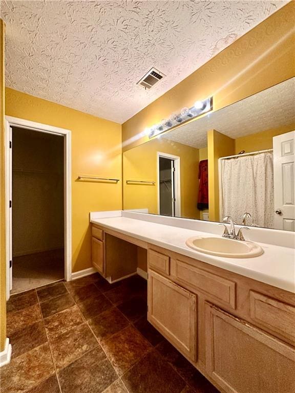 3793 Mays Ct SW, Atlanta, GA 30331 - bathroom featuring vanity, baseboards, and a textured ceiling