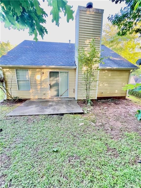 3793 Mays Ct SW, Atlanta, GA 30331 - rear view of property featuring a chimney, a patio area, roof with shingles, and a lawn