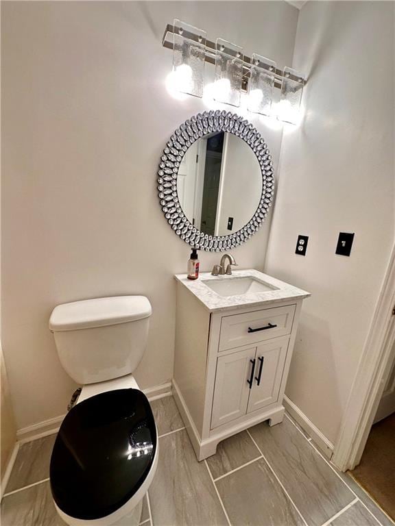 3793 Mays Ct SW, Atlanta, GA 30331 - bathroom featuring baseboards, vanity, and toilet
