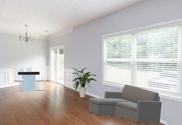 532 Oakside Pl, Acworth, GA 30102 - sitting room with a chandelier, wood finished floors, a textured ceiling, and wainscoting